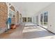 Bright sunroom with brick wall and sliding glass doors at 9095 Highway 701 South, Conway, SC 29527