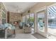 Sunroom with tiled floor, wicker furniture, fireplace and pool access at 92 Preservation Dr., Myrtle Beach, SC 29572
