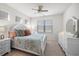 Bedroom with white wooden bed frame, two nightstands, and dresser with mirror at 94 Vineyard Place # 11, Pawleys Island, SC 29585