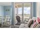 Comfortable living room leads to a balcony with seating and beach view at 9400 Shore Dr. # 311, Myrtle Beach, SC 29572