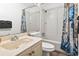Bathroom featuring a shower/tub combo, light tan vanity, and coordinating shower curtain at 9400 Shore Dr. # 311, Myrtle Beach, SC 29572