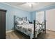 Serene bedroom with a decorative wrought iron bed, soft bedding, and natural light, creating a peaceful sanctuary at 9400 Shore Dr. # 311, Myrtle Beach, SC 29572