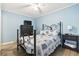 Bedroom with a black metal frame bed, dresser and nightstand, matching starfish themed quilt at 9400 Shore Dr. # 311, Myrtle Beach, SC 29572