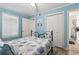 Cozy bedroom features stylish starfish themed quilt, light blue walls, and wood-look floors at 9400 Shore Dr. # 311, Myrtle Beach, SC 29572