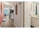 Hallway view into kitchen and bathroom featuring wood flooring, offering both functionality and access to essential areas at 9400 Shore Dr. # 311, Myrtle Beach, SC 29572