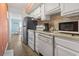 Functional kitchen with white cabinets, stainless steel appliances, and a stylish backsplash, blending convenience with a modern touch at 9400 Shore Dr. # 311, Myrtle Beach, SC 29572