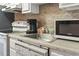 Practical kitchen with white appliances, neutral countertops, and ample cabinet space offering efficiency and comfort at 9400 Shore Dr. # 311, Myrtle Beach, SC 29572