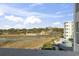 Tranquil view of the pool, waterway, and scenic landscape from the balcony at 9400 Shore Dr. # 311, Myrtle Beach, SC 29572