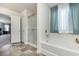 Bright bathroom featuring a soaking tub, shower, and stylish tile flooring at 100 Bendick Ct., Little River, SC 29566