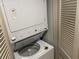 Stacked washer and dryer inside utility closet with louvered doors at 107 S Ocean Blvd. # 707, Myrtle Beach, SC 29572