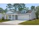 Inviting single-Gathering home featuring gray siding, a well-maintained lawn, and a convenient two-car garage at 123 Tbd Sun Colony Blvd., Longs, SC 29568
