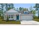 Beautiful single-story home with stylish gray siding, a front porch, and an attached two-car garage at 123 Tbd Sun Colony Blvd., Longs, SC 29568
