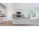 Bright kitchen featuring white cabinets, stainless steel appliances, and a granite countertop island at 123 Tbd Sun Colony Blvd., Longs, SC 29568