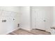 Laundry room with laminate floors, wire shelving, and utility hookups at 123 Tbd Sun Colony Blvd., Longs, SC 29568