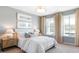 Sun-filled bedroom boasts large windows, soft neutral tones, and stylish furnishings for a tranquil retreat at 124 Tbd Sun Colony Blvd., Longs, SC 29568