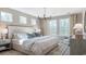 Serene main bedroom showcasing a king bed, neutral tones, hardwood floors, and lots of natural light at 124 Tbd Sun Colony Blvd., Longs, SC 29568
