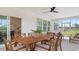 Inviting outdoor dining area with a large wooden table, ceiling fan, and comfortable seating at 124 Tbd Sun Colony Blvd., Longs, SC 29568