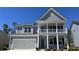 Charming two-story home with a covered porch and a two-car garage, painted in light and dark shades of gray at 1828 Hardwood Ct., Conway, SC 29526