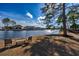 Lakeside backyard with cozy seating, offering serene views and peaceful surroundings at 1829 Wood Stork Dr., Conway, SC 29526