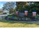 Landscaped entrance to Wild Wing community featuring colorful flowers and brick signage at 1829 Wood Stork Dr., Conway, SC 29526