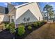 Side view of the home with well-maintained landscaping and stone accents at 1829 Wood Stork Dr., Conway, SC 29526