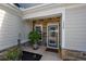 Charming front entryway featuring a decorative glass door, stone accents, and lush landscaping at 1829 Wood Stork Dr., Conway, SC 29526