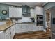 Modern kitchen with stainless steel appliances, white cabinetry, and a stylish range hood at 1829 Wood Stork Dr., Conway, SC 29526