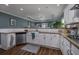 Farmhouse sink and granite countertops in a kitchen with white cabinets and stainless steel appliances at 1829 Wood Stork Dr., Conway, SC 29526