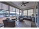Enjoy this cozy sunroom showcasing a ceiling fan, comfortable seating, and serene water views at 1829 Wood Stork Dr., Conway, SC 29526