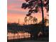 Water view at sunset with the lake reflecting the pink and orange sky at 1829 Wood Stork Dr., Conway, SC 29526