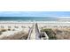 Wooden boardwalk leads to sandy beach with ocean view at 203 Heron Marsh Dr. # 78, Pawleys Island, SC 29585
