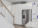 Bright kitchen featuring white cabinets, stainless steel appliances, and convenient staircase access at 2602 Blue Crane Circle # 101, Myrtle Beach, SC 29577