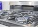 Close-up of stainless steel gas range cooktop with blue flame at 2602 Blue Crane Circle # 101, Myrtle Beach, SC 29577