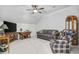 Spacious living room features a ceiling fan, gray sofa, plaid armchair, and a table with a TV at 2602 Blue Crane Circle # 101, Myrtle Beach, SC 29577