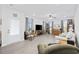 Inviting living room featuring wood-look floors, neutral walls, and abundant natural light from large windows at 2602 Blue Crane Circle # 101, Myrtle Beach, SC 29577