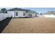 View of large backyard, white privacy fence, and rear elevation featuring a covered patio with seating at 261 Marsh Tacky Loop, Myrtle Beach, SC 29588