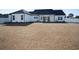 Large backyard with white privacy fence and rear elevation featuring a covered patio with seating at 261 Marsh Tacky Loop, Myrtle Beach, SC 29588