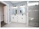 Modern bathroom with dual vanity, a framed mirror, and glass-enclosed shower with gray tile at 261 Marsh Tacky Loop, Myrtle Beach, SC 29588
