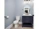 Bathroom features blue vanity, oval mirror, modern lighting, and neutral wall color at 261 Marsh Tacky Loop, Myrtle Beach, SC 29588