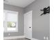 Bedroom features a light gray wall, white door, tv mount and natural light from the bright window at 261 Marsh Tacky Loop, Myrtle Beach, SC 29588