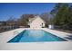 Community pool with chairs, a small building, and surrounded by a black fence at 261 Marsh Tacky Loop, Myrtle Beach, SC 29588