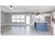 Bright, open kitchen with white cabinets, center island, and modern lighting at 261 Marsh Tacky Loop, Myrtle Beach, SC 29588