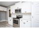Close up of the kitchen with stainless steel appliances, white cabinetry, and marble backsplash and countertops at 261 Marsh Tacky Loop, Myrtle Beach, SC 29588