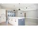 Open-concept kitchen with island, modern lighting fixtures, and seamless access to living area at 261 Marsh Tacky Loop, Myrtle Beach, SC 29588