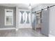 Open living area featuring natural light, barn doors, and wood-look floors at 261 Marsh Tacky Loop, Myrtle Beach, SC 29588