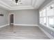 Bright living room with a tray ceiling, recessed lighting, a ceiling fan, and large windows at 261 Marsh Tacky Loop, Myrtle Beach, SC 29588