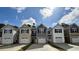 View of newly constructed townhomes with gray siding, white trim, and single-car garages on a sunny day at 265 Christiana Ln. # D, Myrtle Beach, SC 29579