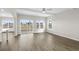 Spacious living room with wood-look floors, ceiling fan and natural light from the sliding glass doors at 336 Happy Valley Dr., Myrtle Beach, SC 29588