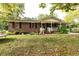 Brick ranch house with covered porch, landscaping, and large yard at 3657 Highway 472, Conway, SC 29526