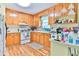 Kitchen with wood cabinets, white appliances, and wood floors at 3657 Highway 472, Conway, SC 29526